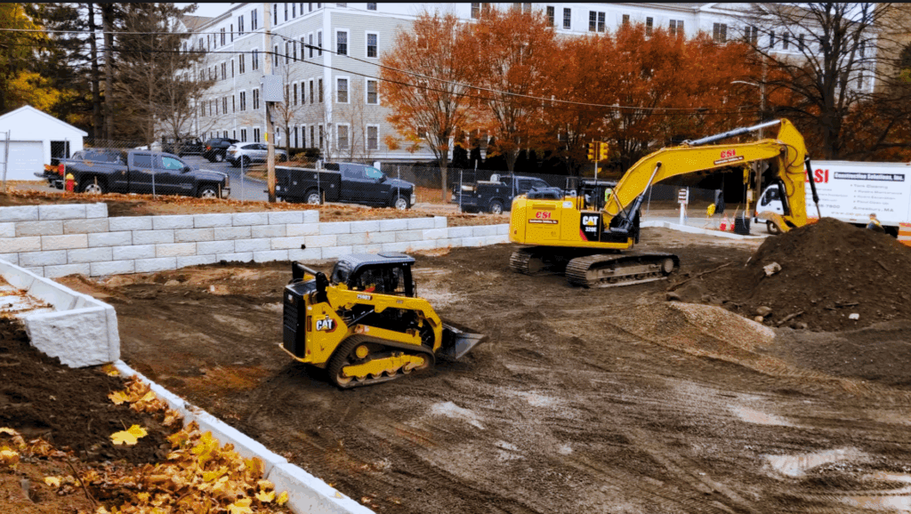 Commercial Property Grading, excavation & site development services; Construction Solutions, Inc. Demolition of old retaining wall and. structures complete, new wall in progress 