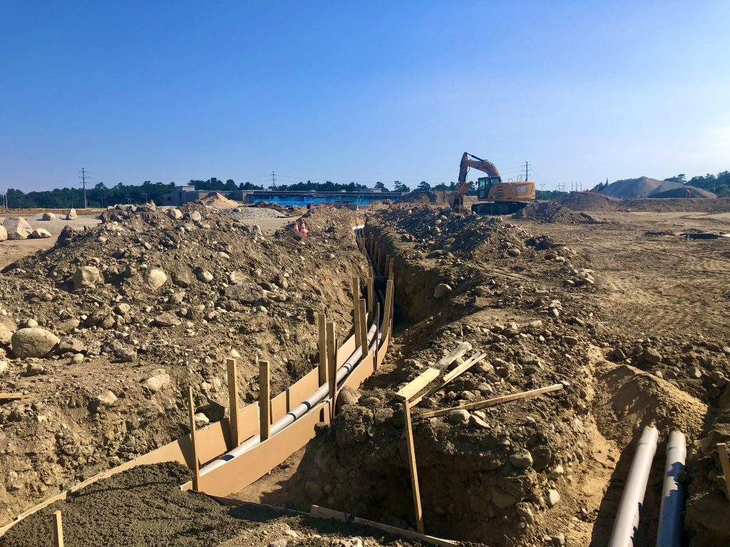 construction solutions install of utility lines and trenches for large shopping plaza in eastern Massachusetts 