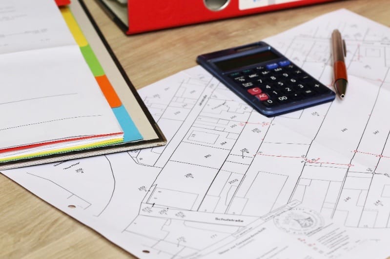 lot planning drawing, calculator and pen for Accessory Dwelling unit building