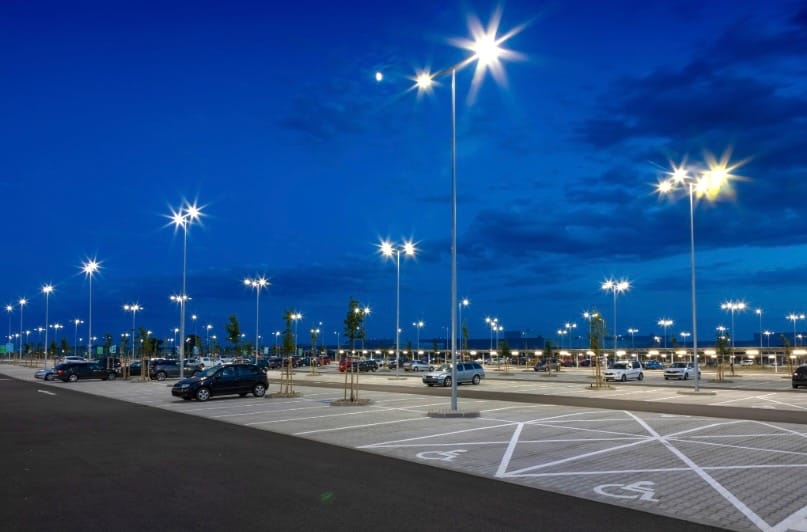 commercial property management, well lit and maintained parking lot at night