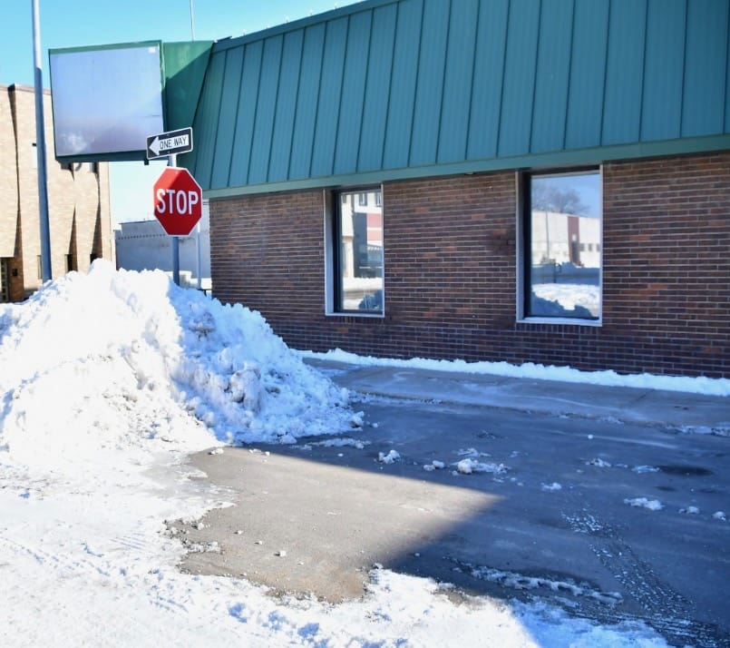 freshly cleaned snow from plowing and side walk clearing at commercial building