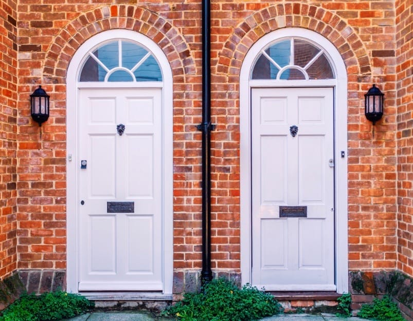 two family brick house door entrances next to each other for in-law apartment verses a tiny home