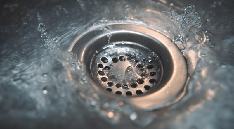 drain in a sink with running water