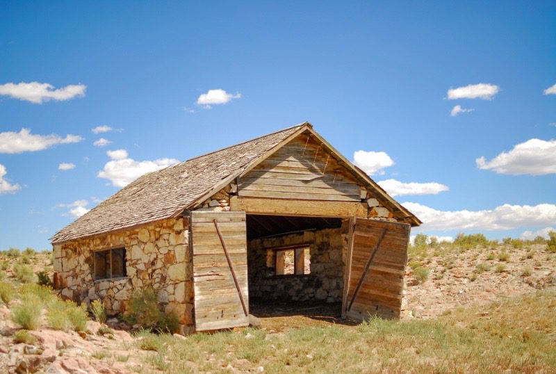 old barn that is structural unsound and in need of replacement. Walls are leaning, improper land grading which allows water to pool and undermines the structural integrity