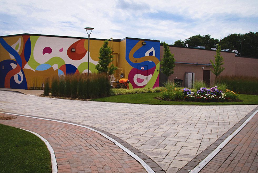 Newly renovated exterior or commercial office building including landscaping, sidewalks and tenant patio
