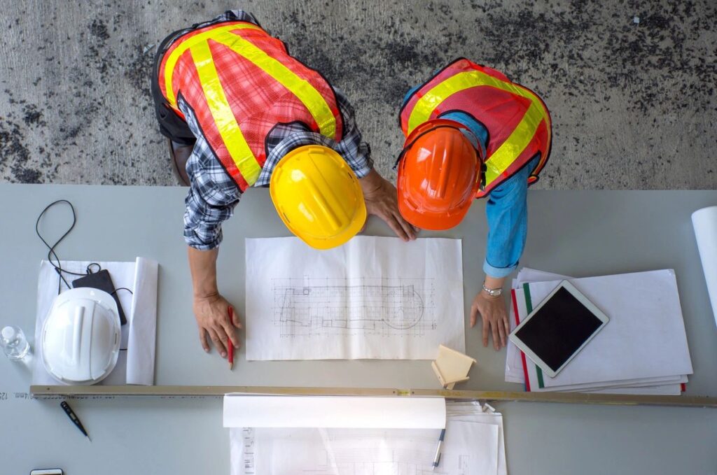 construction engineer and project manager going over final grade numbers
