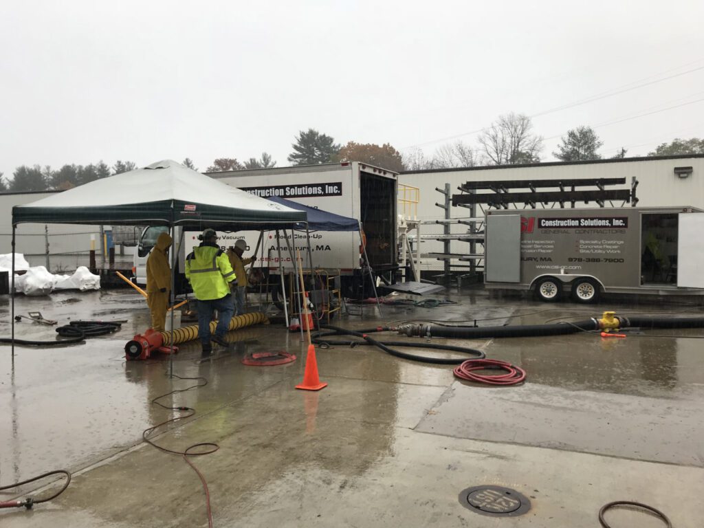 Confined space entry supervising and and responsible persons above entry point monitoring crew and data