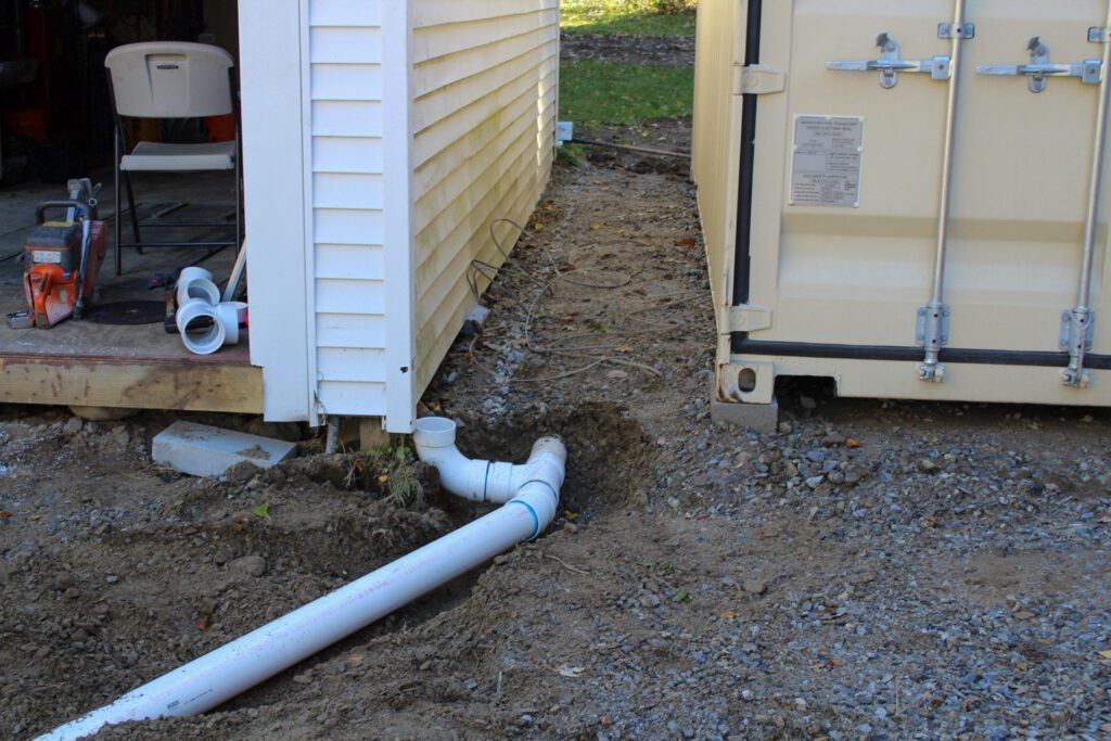 installation of gutter piping connecting to an under ground French drain system